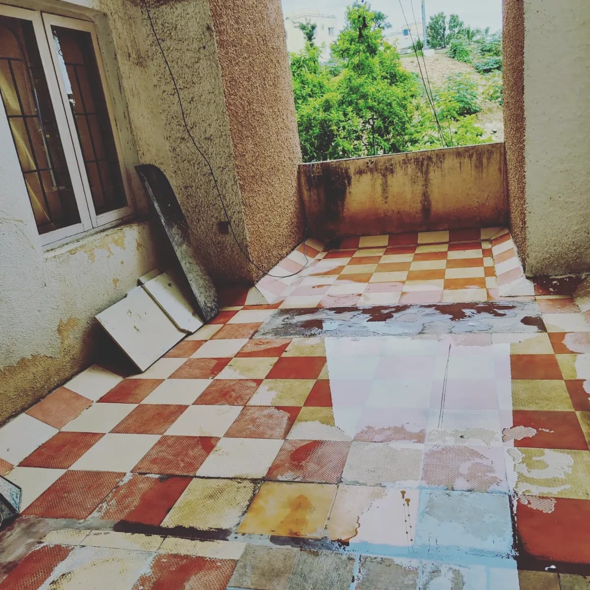 Terrace before renovation - old tiles and weathered space